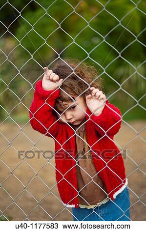Young girl behind fence View Large Photo Image Stock Image - Young girl behind fence. Fotosearch