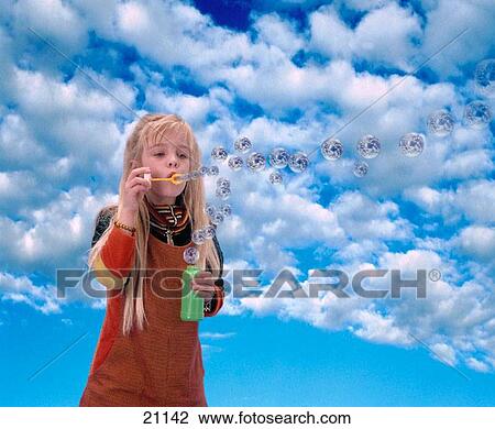 Young girl blowing earth bubbles View Large Photo Image Stock Image - Young girl blowing earth bubbles. Fotosearch