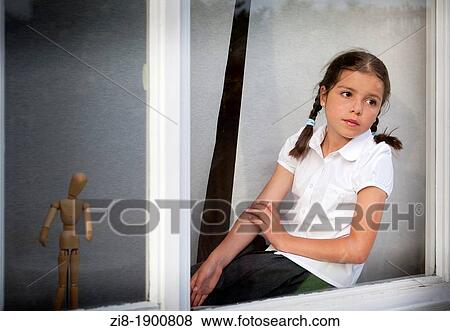 Young girl by the window View Large Photo Image Stock Photo - Young girl by the window. Fotosearch