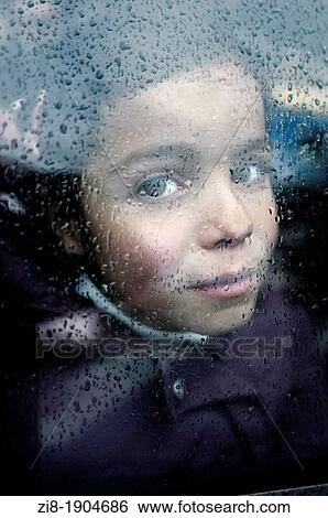Stock Photograph - Young girl by the window. Fotosearch