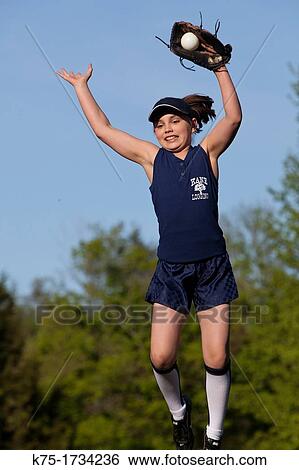 Stock Photograph - Young girl catches softball. Fotosearch