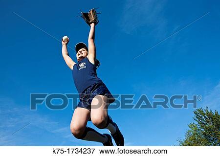 Stock Photo - Young girl catches the ball. Fotosearch