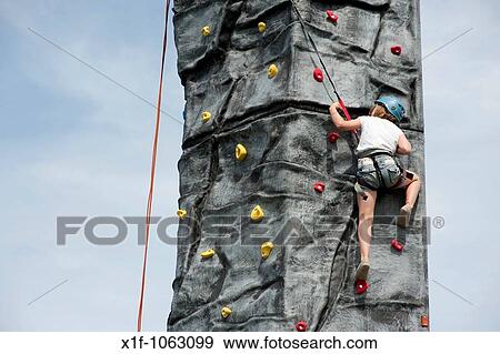 Young girl climbing on a Mobile climbing wall tower at Aberystwyth Leisure Centre, Wales UK View Large Photo Image Stock Photo - Young girl climbing on a Mobile climbing wall tower at Aberystwyth Leisure Centre, Wales UK. Fotosearch