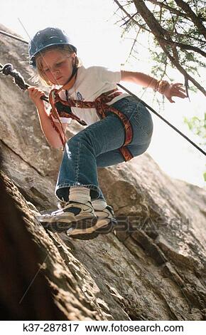 Young girl climbing rock face at rock climbing school. Telluride. Colorado. USA View Large Photo Image Stock Photo - Young girl climbing rock face at rock climbing school. Telluride. Colorado. USA. Fotosearch