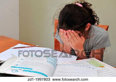 Young girl cries alone while sitting on the dining room table doing homework. View Large Photo Image Stock Image - Young girl cries alone while sitting on the dining room table doing homework.. Fotosearch