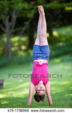 young girl doing a handstand View Large Photo Image Stock Photo - young girl doing a handstand. Fotosearch