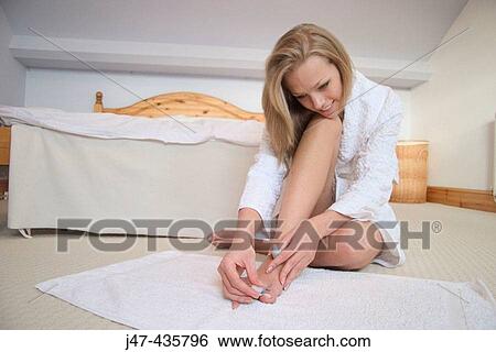 Young girl doing nail varnish on her bedroom floor, smiling View Large Photo Image Stock Photograph - Young girl doing nail varnish on her bedroom floor, smiling. Fotosearch