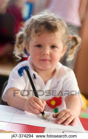 Young girl drawing at school View Large Photo Image Picture - Young girl drawing at school. Fotosearch