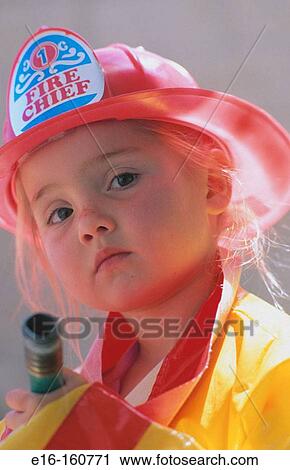 Young girl dressed in firefighter's clothes View Large Photo Image Stock Image - Young girl dressed in firefighter's clothes. Fotosearch