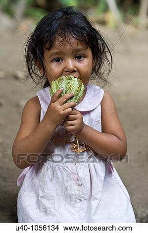 Young girl eating raw cacao View Large Photo Image Picture - Young girl eating raw cacao. Fotosearch