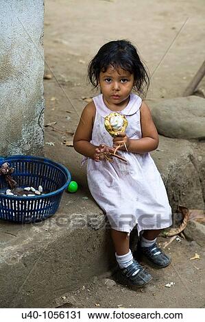 Young girl eating raw cacao View Large Photo Image Stock Image - Young girl eating raw cacao. Fotosearch