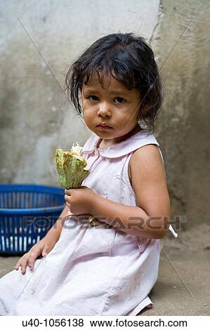Young girl eating raw cacao View Large Photo Image Stock Photo - Young girl eating raw cacao. Fotosearch