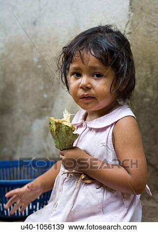Young girl eating raw cacao View Large Photo Image Stock Photo - Young girl eating raw cacao. Fotosearch