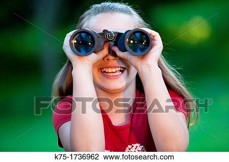 Young girl enjoying her binoculars View Large Photo Image Stock Image - Young girl enjoying her binoculars. Fotosearch