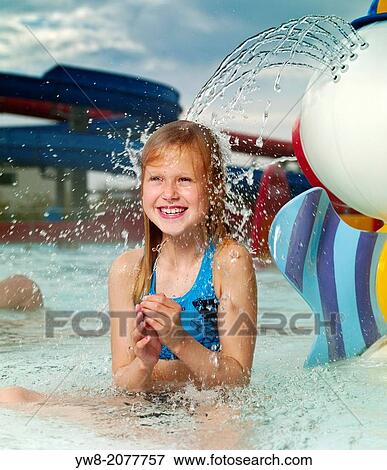 Stock Photo - Young girl enjoying the outdoor geothermal heated swimming pool, Iceland.. Fotosearch