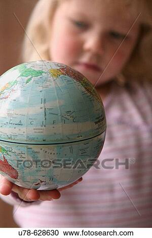 Young girl examining world globe View Large Photo Image Stock Image - Young girl examining world globe. Fotosearch