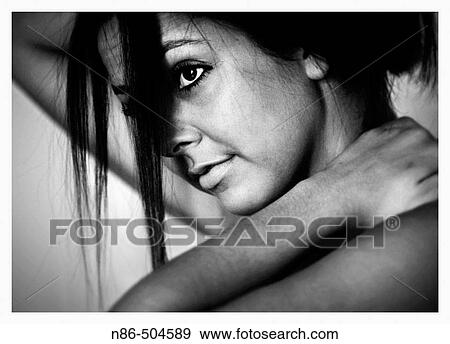 Stock Photo - Young girl fixing her hair. Fotosearch