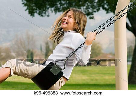 young girl having fun on the swing View Large Photo Image Stock Image - young girl having fun on the swing. Fotosearch