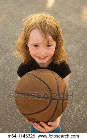 Young girl holding a basketball View Large Photo Image Stock Photography - Young girl holding a basketball. Fotosearch