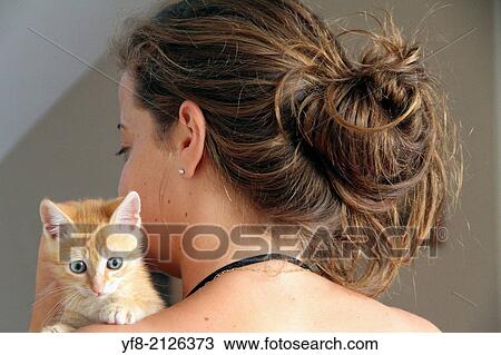 Stock Image - young girl holding a cat.. Fotosearch