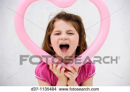 Young girl holding heart View Large Photo Image Picture - Young girl holding heart. Fotosearch