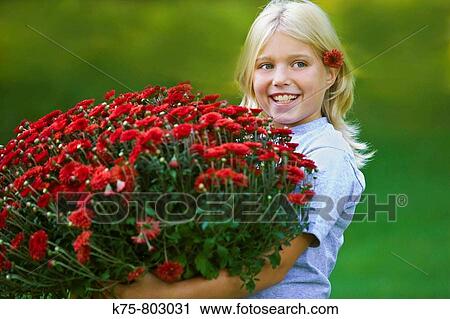 Young girl holding large basket of mums View Large Photo Image Stock Image - Young girl holding large basket of mums. Fotosearch