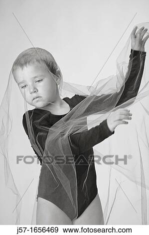 Young girl in a black leotard with pediatric cancer leukimia playing with fabric in the studio View Large Photo Image Stock Photo - Young girl in a black leotard with pediatric cancer leukimia playing with fabric in the studio. Fotosearch