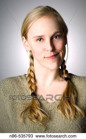 Stock Image - Young girl in braids smiling. Fotosearch
