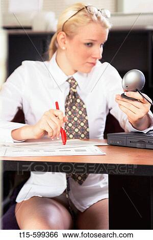 Young girl in her 20's working from home and meeting with clients/coworkers through web cam only half dressed as needed View Large Photo Image Stock Photograph - Young girl in her 20's working from home and meeting with clients/coworkers through web cam only half dressed as needed. Fotosearch