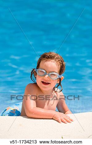 Stock Image - Young girl in swimming pool. Fotosearch