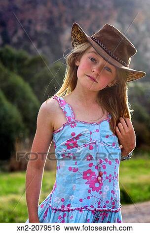 Young girl in the country wearing cowboy hat View Large Photo Image Stock Photo - Young girl in the country wearing cowboy hat. Fotosearch