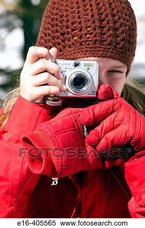 young girl in winter taking photos View Large Photo Image Stock Photography - young girl in winter taking photos. Fotosearch