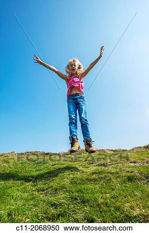 young girl jumping, gummer's how, lake district, cumbria, england, uk, europe. View Large Photo Image Stock Image - young girl jumping, gummer's how, lake district, cumbria, england, uk, europe.. Fotosearch