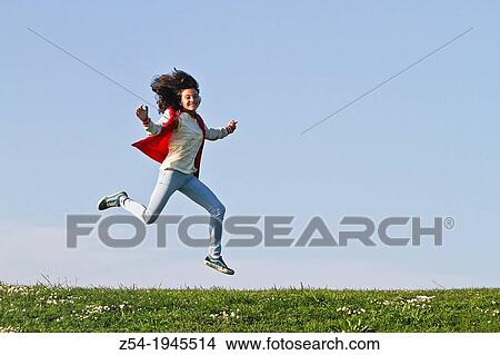 Young girl jumping in air, Spain. View Large Photo Image Picture - Young girl jumping in air, Spain.. Fotosearch