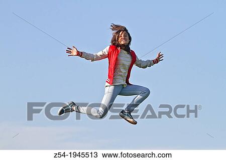 Young girl jumping in air, Spain. View Large Photo Image Stock Image - Young girl jumping in air, Spain.. Fotosearch