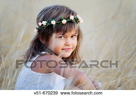 Young girl looking at camera in the countryside View Large Photo Image Stock Photo - Young girl looking at camera in the countryside. Fotosearch