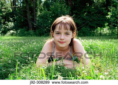 Stock Photo - Young girl looking at camera.. Fotosearch