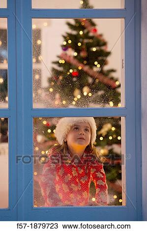 Young girl looking out of the window waiting for Santa to arrive View Large Photo Image Stock Image - Young girl looking out of the window waiting for Santa to arrive. Fotosearch