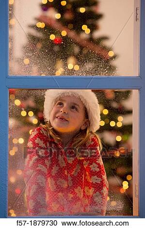 Young girl looking out of the window waiting for Santa to arrive View Large Photo Image Stock Image - Young girl looking out of the window waiting for Santa to arrive. Fotosearch