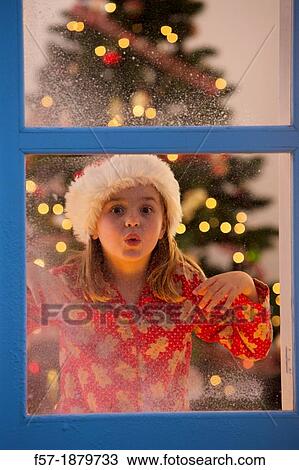 Young girl looking out of the window waiting for Santa to arrive View Large Photo Image Stock Image - Young girl looking out of the window waiting for Santa to arrive. Fotosearch