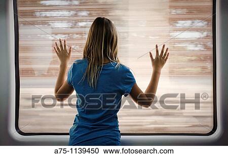 Young girl looking through window, rear view View Large Photo Image Stock Image - Young girl looking through window, rear view. Fotosearch