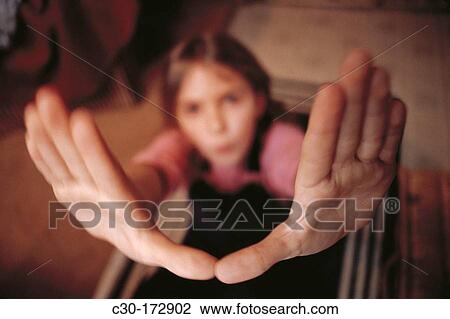 Young girl makes playful gesture View Large Photo Image Stock Image - Young girl makes playful gesture. Fotosearch
