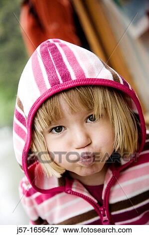 Young girl making a funny face at the camera View Large Photo Image Stock Photo - Young girl making a funny face at the camera. Fotosearch
