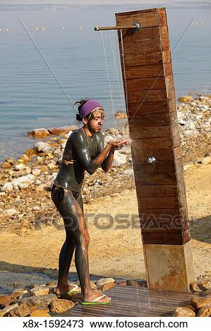 Young girl making shower on the dead sea, Jordan View Large Photo Image Stock Image - Young girl making shower on the dead sea, Jordan. Fotosearch