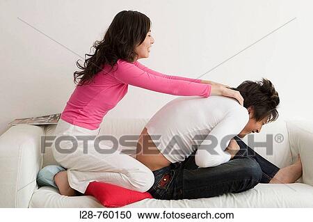 Young girl massaging her boyfriend's shoulder View Large Photo Image Stock Image - Young girl massaging her boyfriend's shoulder. Fotosearch