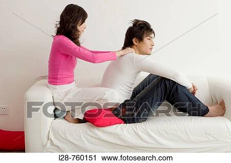 Young girl massaging her boyfriend's shoulder View Large Photo Image Stock Image - Young girl massaging her boyfriend's shoulder. Fotosearch