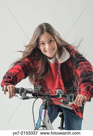 Young girl on a bike View Large Photo Image Stock Photo - Young girl on a bike. Fotosearch