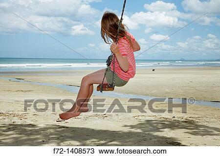 Young Girl on Rope Swing under Pohutukawa Tree, Waihi Beach, Coromandel, North Island, New Zealand View Large Photo Image Stock Image - Young Girl on Rope Swing under Pohutukawa Tree, Waihi Beach, Coromandel, North Island, New Zealand. Fotosearch