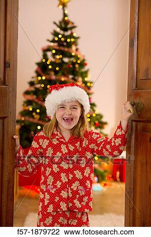 Young girl opening the living room doors at Christmas time View Large Photo Image Stock Image - Young girl opening the living room doors at Christmas time. Fotosearch