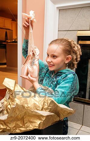 Young girl opens a present containing new ballet pointe shoes. View Large Photo Image Stock Image - Young girl opens a present containing new ballet pointe shoes.. Fotosearch